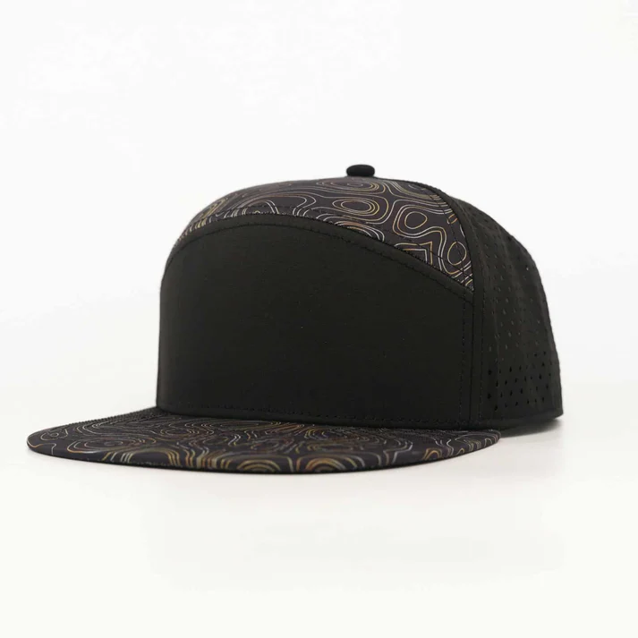 Black snapback hat with perforated mesh side panels and a brim and front panels featuring a subtle geometric swirl pattern.